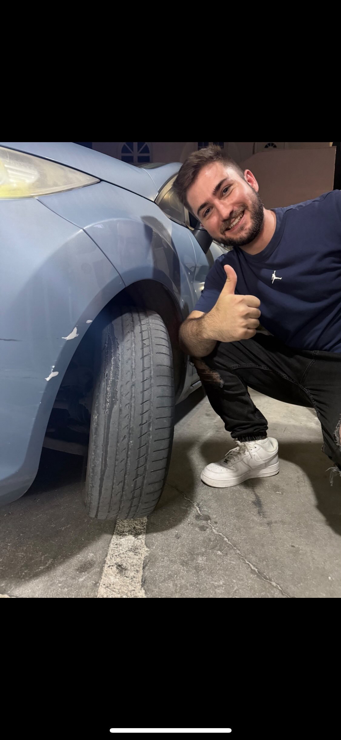 Mike Georgis mugshot-style photo next to his Fiesta's slick tyre