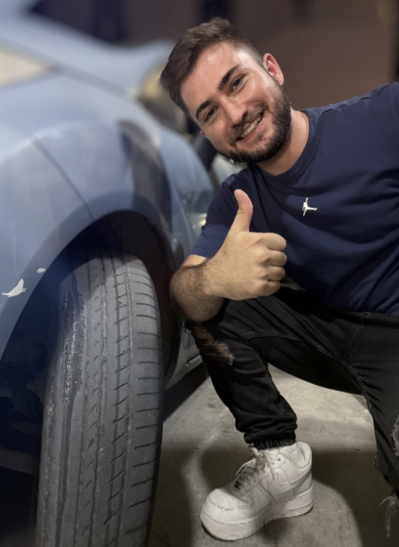 Mike Georgis giving a thumbs up next to his completely finished front tyre